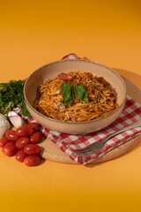 Bolognese pasta on colorful background