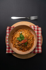 Bolognese pasta on black background top view