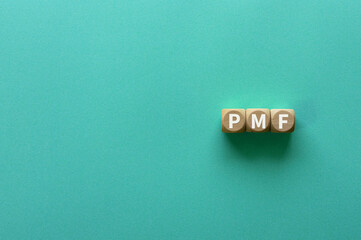 There is wood cube with the word PMF. It is an abbreviation for Product Market Fit as eye-catching image.