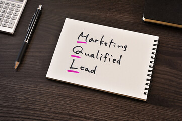 There is notebook with the word Marketing Qualified Lead. It is as an eye-catching image.