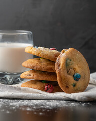 Homemade M&Ms cookies served with a glass of milk