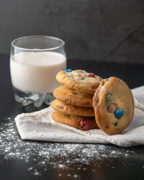Homemade M&Ms cookies served with a glass of milk
