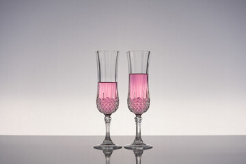 Champagne glass on shiny gray surface
