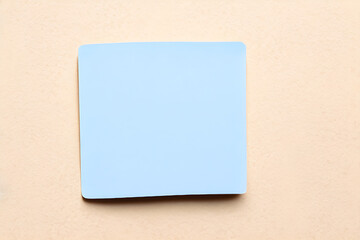blue sticky note on a wall