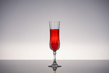 Champagne glass on shiny gray surface