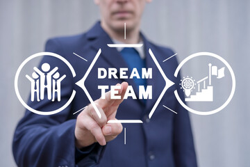 Businessman using virtual touch screen presses inscription: DREAM TEAM. Successful dream team,...