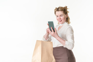 Cheerful woman holding smartphone reading online messages, browsing offers with sales and discounts