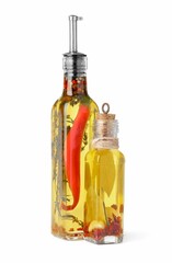 Obraz na płótnie Canvas Glass bottles of cooking oil with spices and herbs on white background