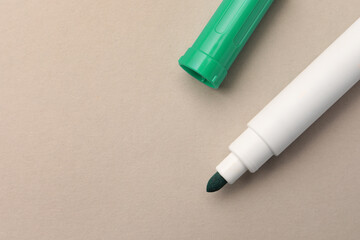Bright green marker on beige background, flat lay. Space for text