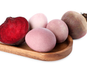Colorful Easter eggs painted with natural dye and beets on white background