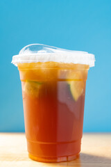 side view cup of iced lemon vertical composition