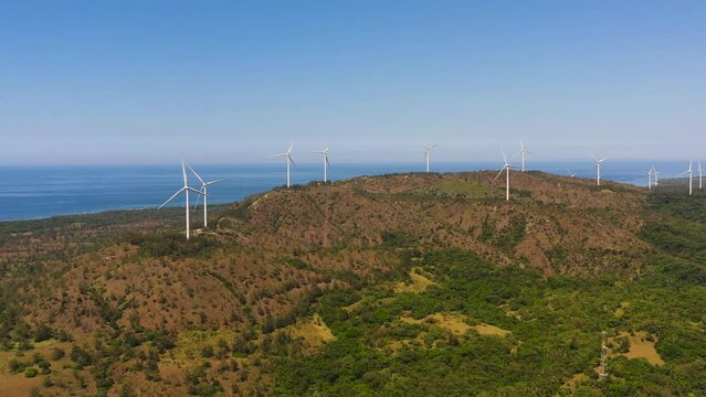 Top view of Wind turbines for electric power production on the seashore. Wind power plant. Ecological landscape. Philippines.