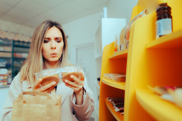 Customer Reading the Label of Ingredients and Caloric Information. Client examining the nutritional...