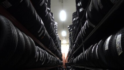 Car tire row on shelf in garage shop automobile