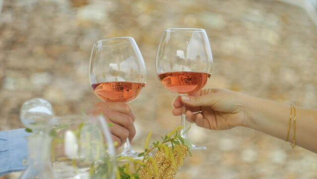 Couple Holding Rose Wine Tapping Glasses For Cheers 