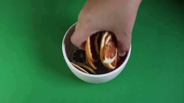 Zesty Citrus Delights: Dehydrated Citrus Falling into Ceramic Ja