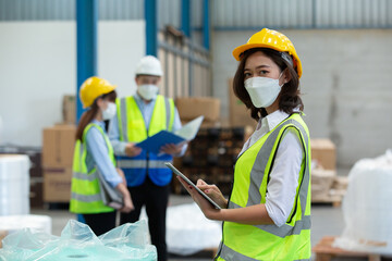 Female professional worker use tablet checking stock product in warehouse logistic storage. woman employee  checklist package delivery factory.