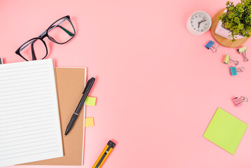 Pink office desk table Top view with copy space. Flat lay.