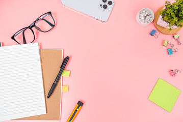 Pink office desk table Top view with copy space. Flat lay.