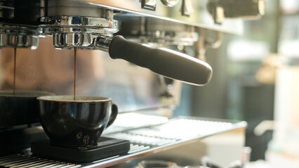 Coffee machine making espresso in coffee shop, shallow depth of field