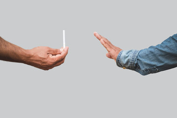 Man's hand holding a cigarette and passed to hand show signs of decline. Concept for no smoking. - obrazy, fototapety, plakaty