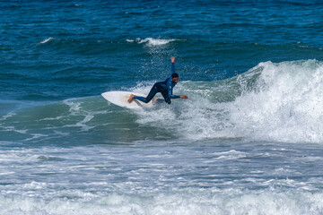 Surfer riding waves in Furadouro Beach