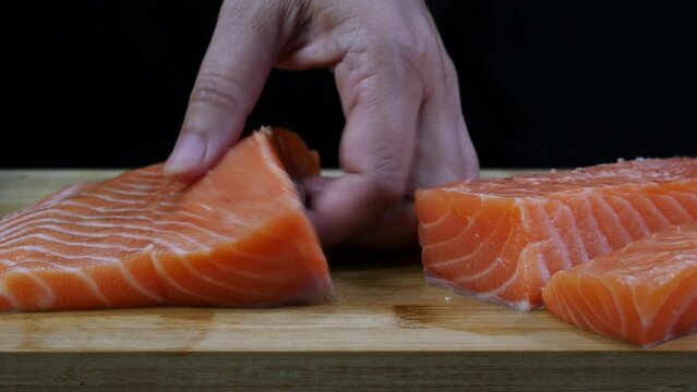 chef is cutting fresh salmon trout fillet prepare for making food, sushi sashimi cooking delicious famous asian japanese korean sea food