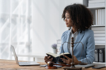 American woman lawyer or businesswoman African working with laptop searching for information,...
