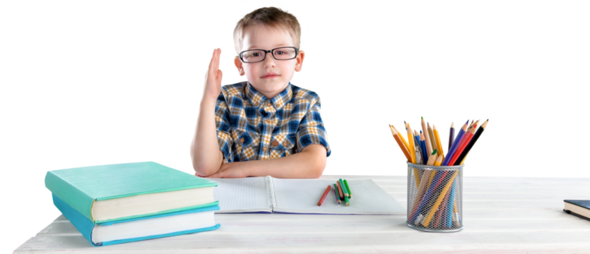 Happy child writing in a notebook in the classroom