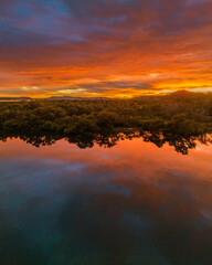 A moody winter sunrise waterscape with clouds