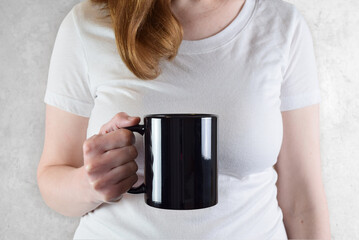 11 oz. Black Coffee Mug Mockup - Glossy Black Mug Held by Young Woman - Powered by Adobe