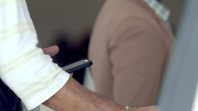 Man using an airplane E-ticket on his smartphone to self check-in