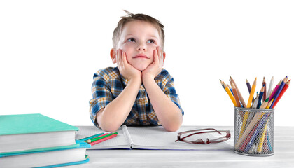 Happy child writing in a notebook in the classroom