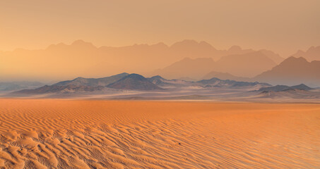 Panoramic view of orange sand dune desert with orange mountains and hill - Namib desert, Namibia