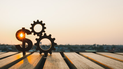 Silhouette of Dollar model and gear model with evening sky. Concepts for methods, systems of...