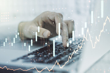 Double exposure of abstract creative financial chart with hand typing on computer keyboard on background, research and strategy concept