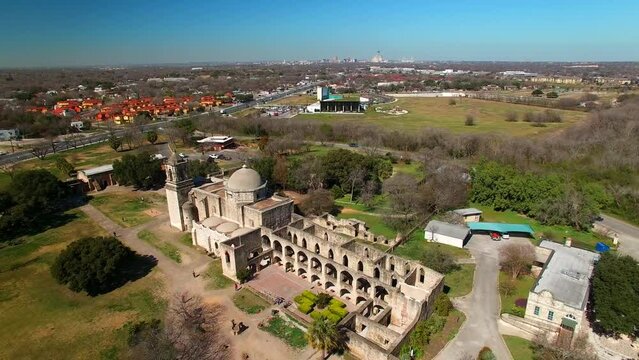Aerial Shot Of Mission San Jose Church Against Blue Sky, Drone Ascending Backward Over City On Sunny Day - San Antonio, Texas