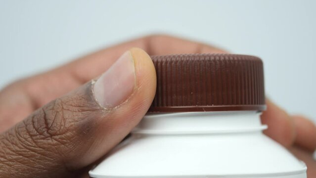 open a cap of a plastic water bottle 