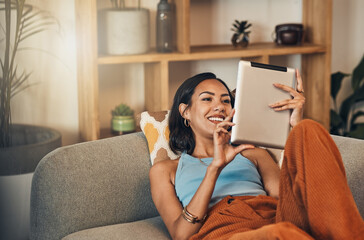 Woman relax on couch with tablet, online streaming with internet and reading ebook or watching film...