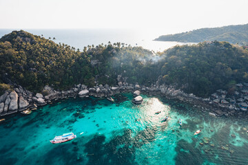 Island and boat in clear sea at Koh Tao