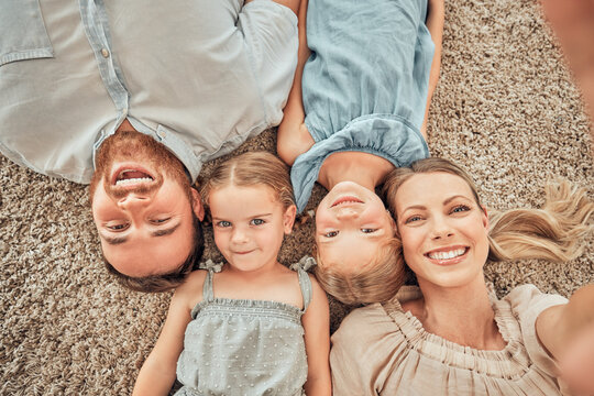 Top view, selfie and portrait of parents and children on living room floor for bonding, quality time and relax. Happy family, smile and mom and dad with girls for care, love and take picture at home