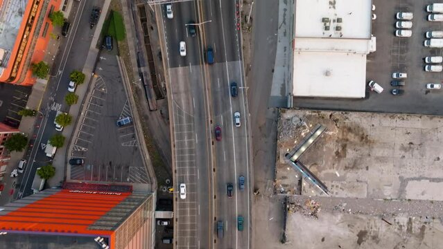 Aerial view above traffic on I-87 in Mott Haven, sunset in Bronx, NY, USA - top down, drone shot