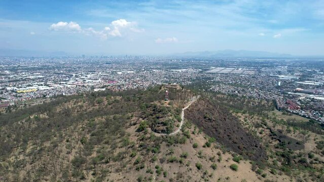 take off drone shot of east Mexico city over cerro de la estrella in iztapalapa