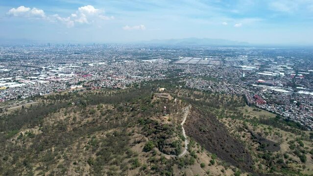 orbital drone shot of east Mexico city over cerro de la estrella in iztapalapa