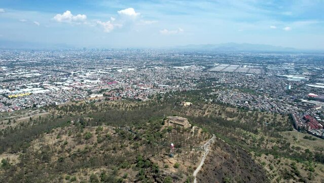 frontal drone shot of east Mexico city over cerro de la estrella in iztapalapa