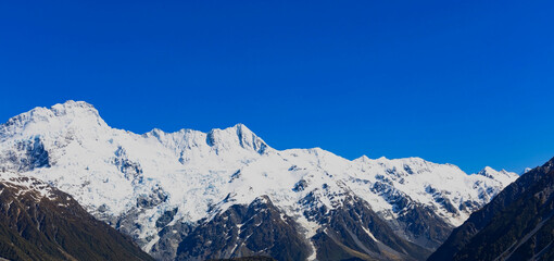 The mountain view of  alpine as snow-capped mount peaks in  Winter mountains, panorama scene