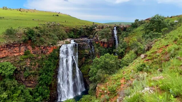 Lisbon Falls waterfalls Sabie Blyde River Mpumalanga Graskop South Africa cinematic tripod slow motion multiple drops stunning beaitufil sun daytime afternoon green lush Johannesburg landscape Kruger