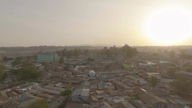 Aerial drone shot of Kibera in Nairobi, Kenya with the sun setting in the evening.