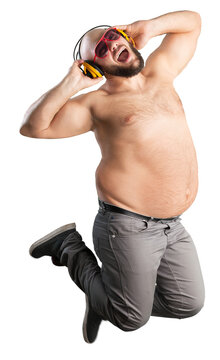 The cheerful fat man is listening to music standing and dancing