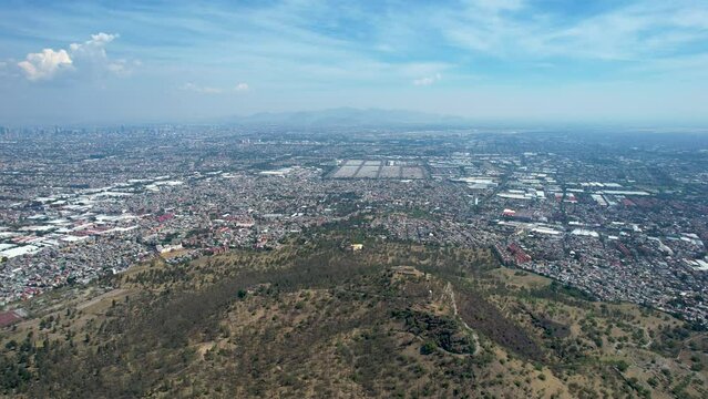 side drone shot of east Mexico city over cerro de la estrella in iztapalapa in mexico